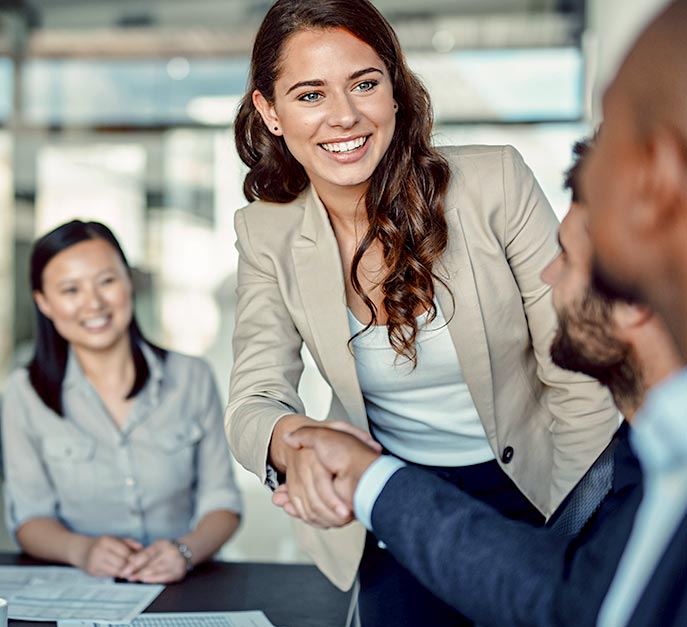 Image of a sales person establishing a successful business relationship with a team of merchants.